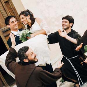 reportage matrimonio in Toscana: tre giovani frati francescani che hanno celebrato le nozze con gli sposi in posa per i fotografi